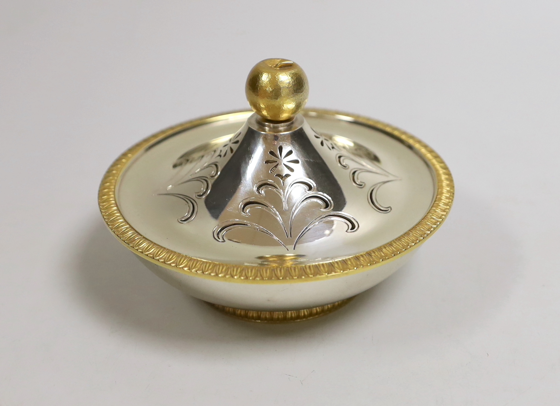 An Elizabeth II Asprey & Co parcel gilt silver circular pomander, with apple finial, diameter 12.5cm, London, 1966, 11oz, in original fitted Asprey & Co case.